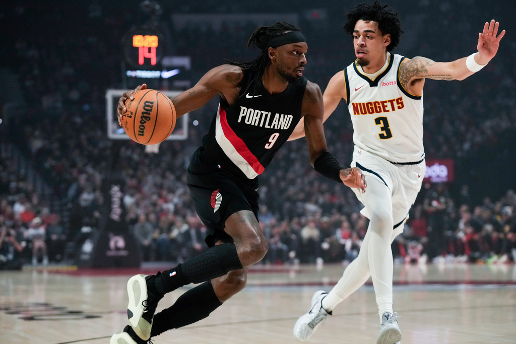 Portland Trail Blazers forward Jerami Grant (9) drives to the basket past Denver Nuggets guard Julian Strawther (3) during the first half of an NBA basketball game Friday, Feb. 20, 2026, in Portland, Ore. (AP Photo/Jenny Kane)