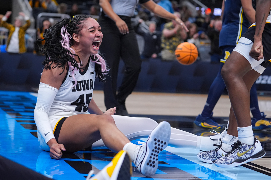 Iowa forward Hannah Stuelke (45) celebrates after being fouled by Michigan in the second half of an NCAA college basketball game in the semifinals of the Big Ten Conference tournament, Saturday, March 7, 2026 in Indianapolis. (AP Photo/Michael Conroy)