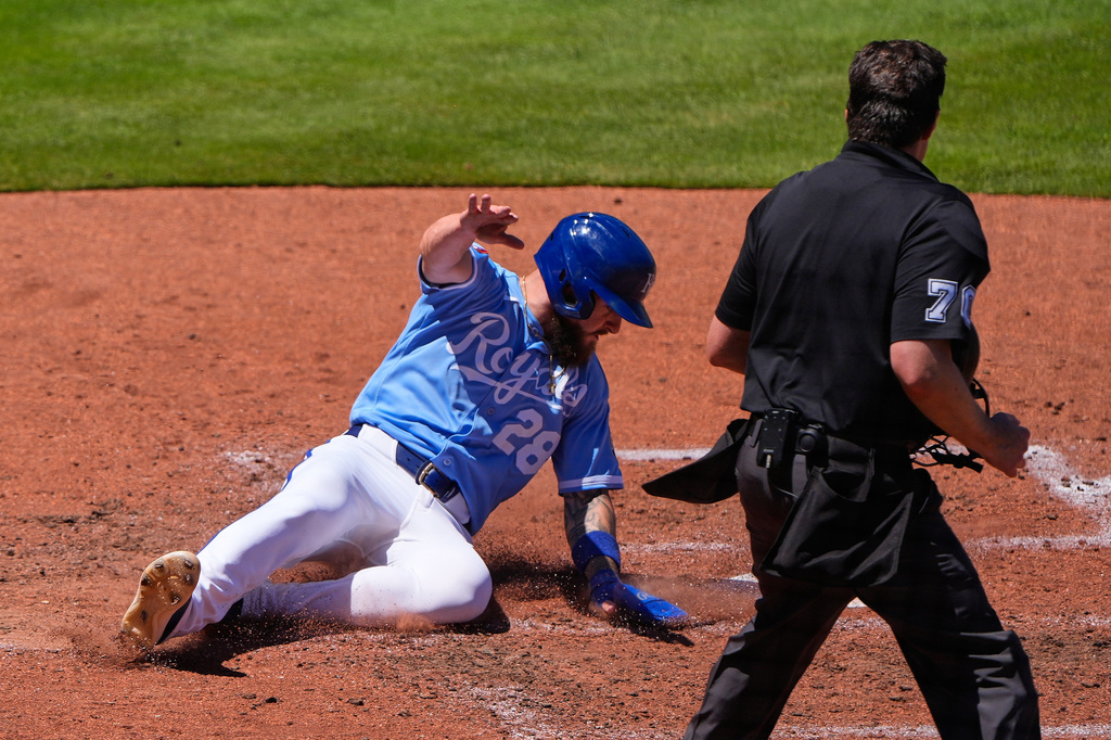 Kansas City Royals' Kyle Isbel slides home to score on a two-run single hit by Salvador Perez during the fifth inning of a baseball game against the Seattle Mariners, Sunday, May 24, 2026, in Kansas City, Mo. (AP Photo/Charlie Riedel)