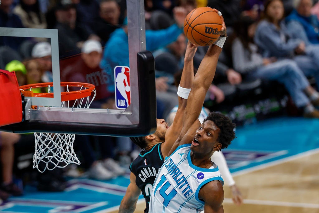 Charlotte Hornets forward Moussa Diabate (14) drives for a dunk past Portland Trail Blazers forward Toumani Camara during the second half of an NBA basketball game in Charlotte, N.C., Saturday, Feb. 28, 2026. (AP Photo/Nell Redmond)