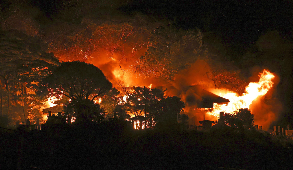 Smoke rises over buildings after a fire in Oita, southern Japan, Wednesday, Nov. 19, 2025. (Kyodo News via AP)