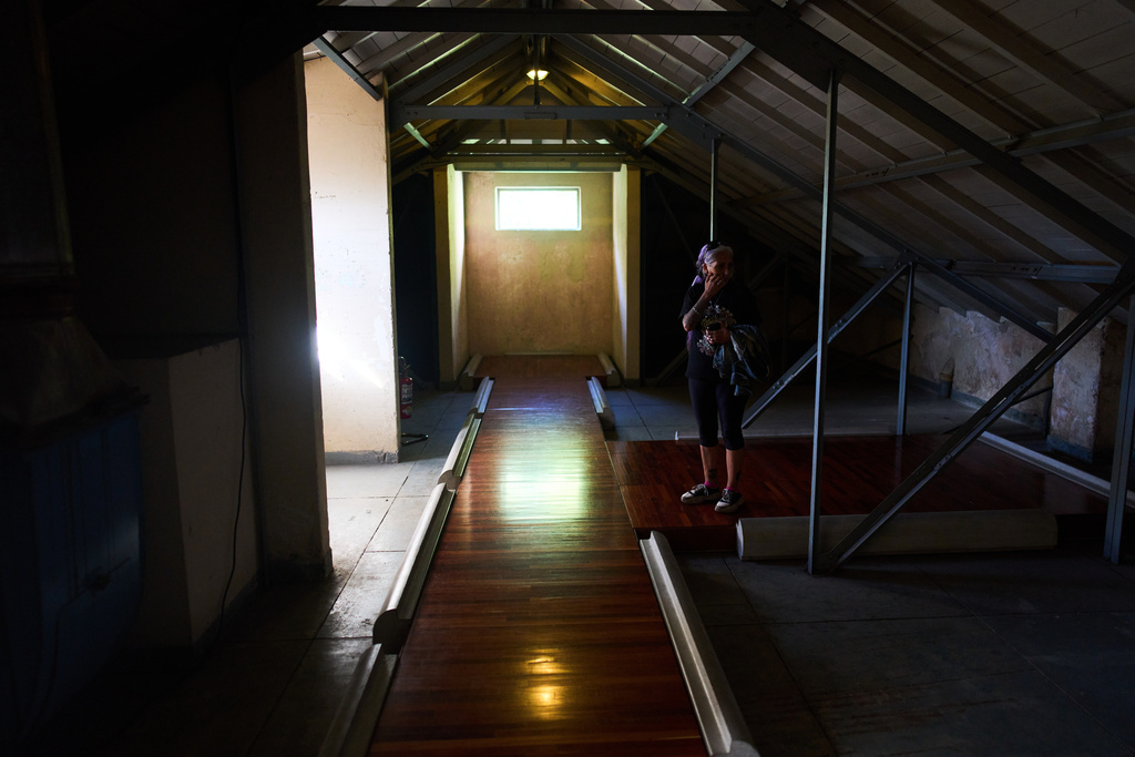 A visitor walks in the "capucha" area, Spanish for hood, where detainees were hooded and tortured at ESMA, an illegal detention center under the military dictatorship that is now the Museum of Space for Memory and the Promotion and Defense of Human Rights, in Buenos Aires, Argentina, Wednesday, March 18, 2026. (AP Photo/Rodrigo Abd)