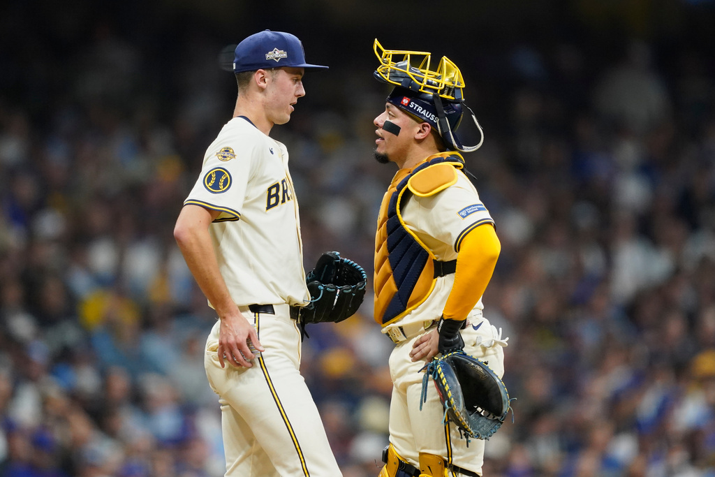 Milwaukee Brewers relief pitcher Jacob Misiorowski (32) and catcher William Contreras (24) talk during the fourth inning of Game 2 of baseball's National League Division Series against the Chicago Cubs Monday, Oct. 6, 2025, in Milwaukee. (AP Photo/Kayla Wolf)