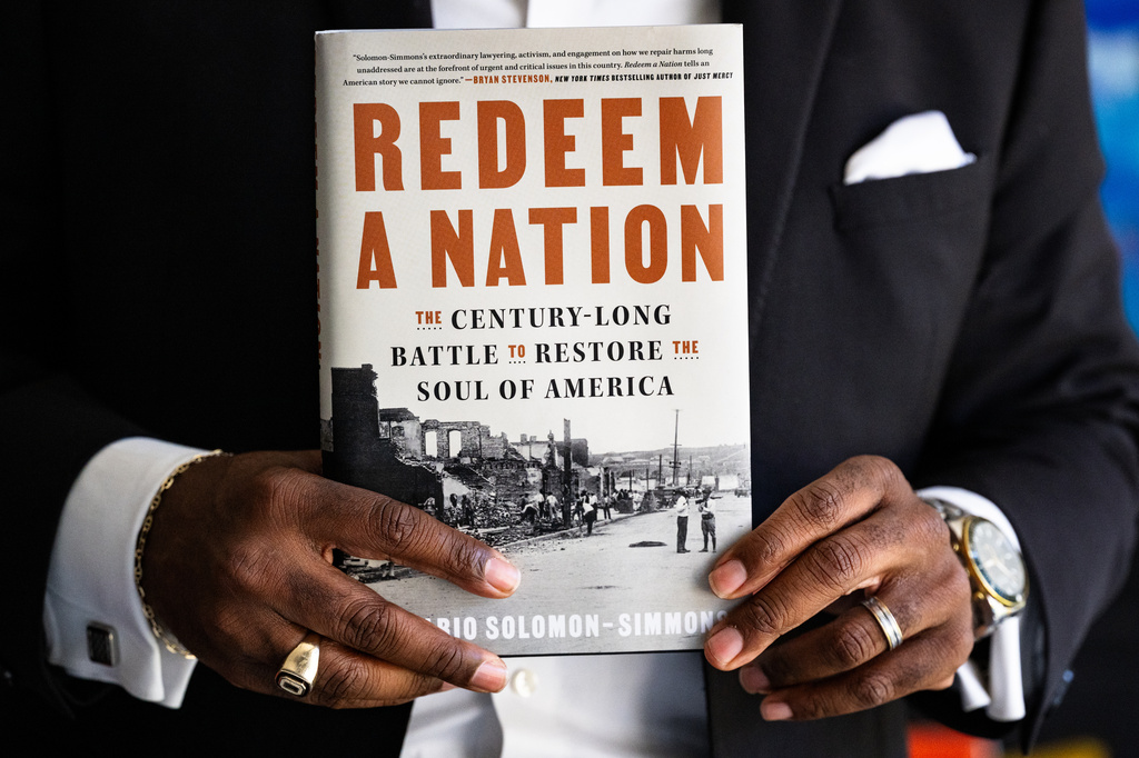 Damario Solomon-Simmons poses for a portrait at The Root Co-working space on Saturday, May 2, 2026, in Tulsa, Okla. Solomon-Simmons is the author of a new book about reparations over the Tulsa Race Massacre (AP Photo/Milo Gladstein)