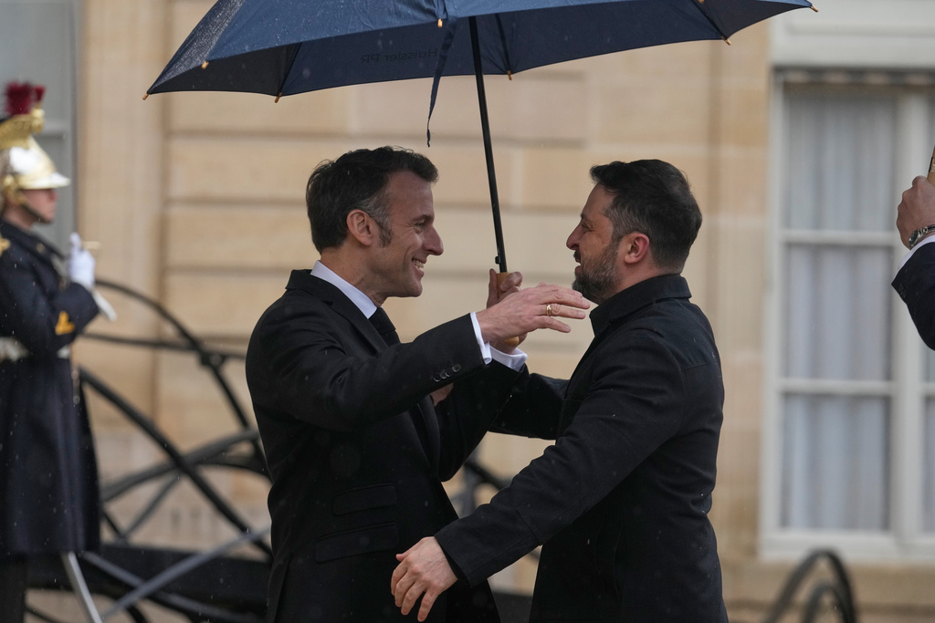 France's President Emmanuel Macron, left, welcomes Ukrainian President Volodymyr Zelenskyy prior to a meeting at the Elysee Palace, Friday, March 13, 2026, in Paris, France. (AP Photo/Michel Euler)