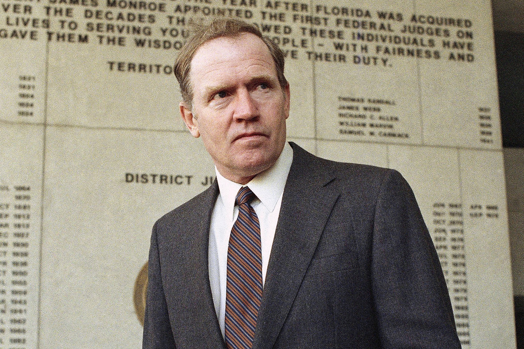 FILE - Eugene Hasenfus stands outside U.S. District Court in Miami, Tuesday, Dec. 13, 1986 after appearing at a status hearing in his lawsuit against two Iran-Contra figures. (AP Photo/Kathy Willens, File)