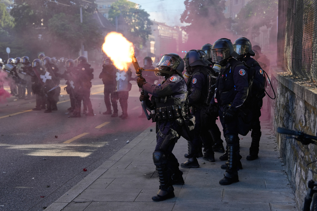 Police fire a tear gas canister during a "No G7" demonstration in Geneva, Switzerland, Sunday, June 14, 2026, ahead of the G7 summit scheduled to take place June 15-17. (AP Photo/Baz Ratner)