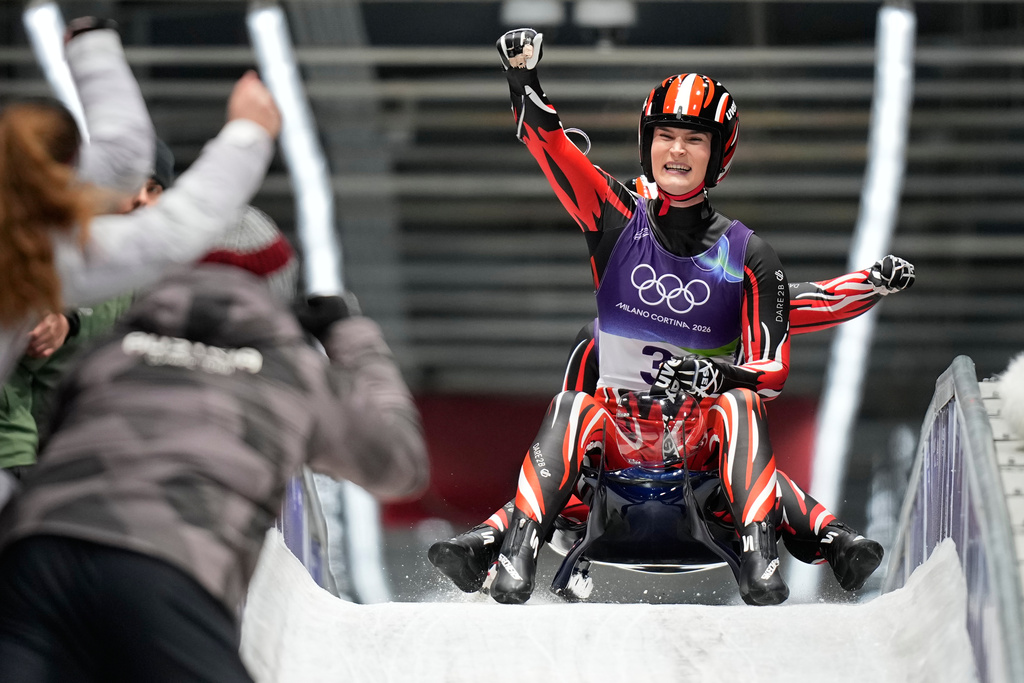 Austria's Selina Egle, front, and Lara Michaela Kipp, rear, celebrate as they arrive at the finish during a women's doubles luge run at the 2026 Winter Olympics, in Cortina d'Ampezzo, Italy, Wednesday, Feb. 11, 2026. (AP Photo/Aijaz Rahi)