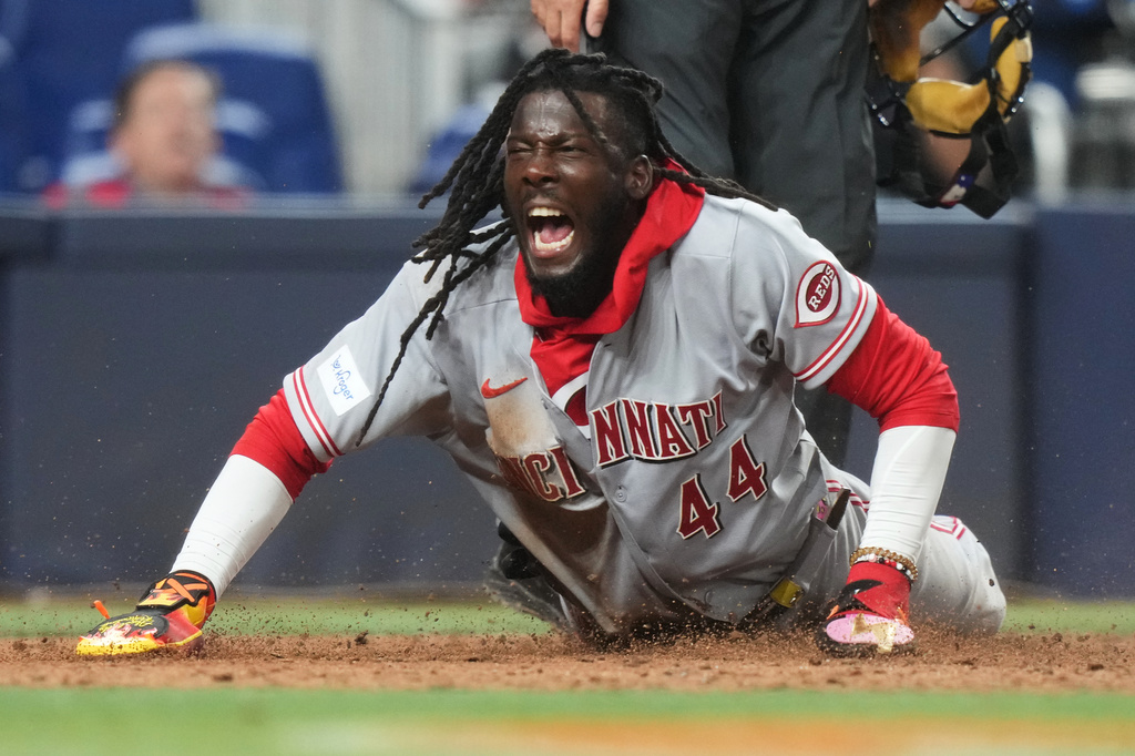 Cincinnati Reds' Elly de la Cruz reacts after scoring on a wild pitch by Miami Marlins relief pitcher Anthony Bender during the ninth inning of a baseball game, Tuesday, April 7, 2026, in Miami. (AP Photo/Lynne Sladky)