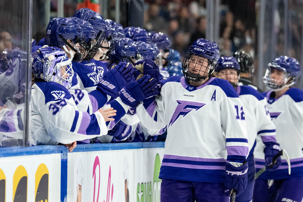 Minnesota Frost's Kelly Pannek (12) celebrates with teammates after her goal against the Vancouver Goldeneyes during the third period of a PWHL hockey game in Vancouver, British Columbia, Saturday, April 25, 2026. (Ethan Cairns/The Canadian Press via AP)