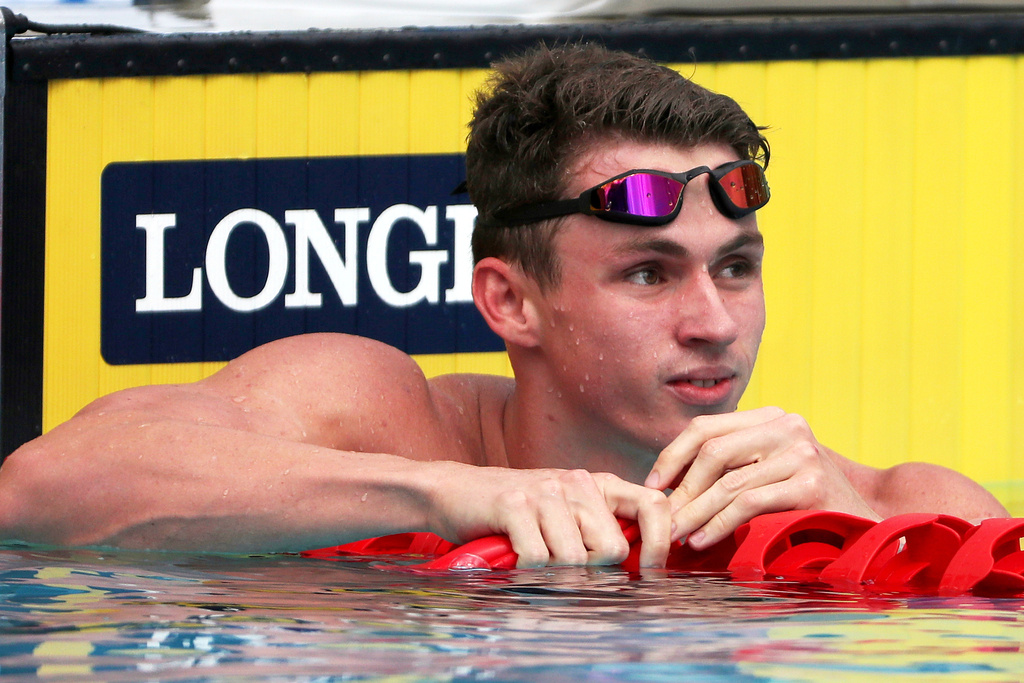 FILE - England's Ben Proud reacts after he was disqualified in his men's 50m butterfly heat during the 2018 Commonwealth Games at the Aquatic Centre on the Gold Coast, Australia, April 5, 2018. (AP Photo/Rick Rycroft, File)