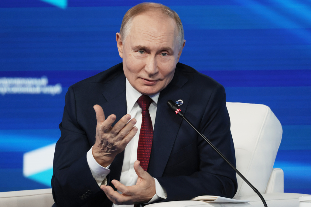 Russian President Vladimir Putin gestures as he answers questions during a meeting with foreign policy experts at the Valdai Discussion Club in the Black Sea resort of Sochi, Russia, on Thursday, Oct. 2, 2025. (Mikhail Metzel, Sputnik, Kremlin Pool Photo via AP)