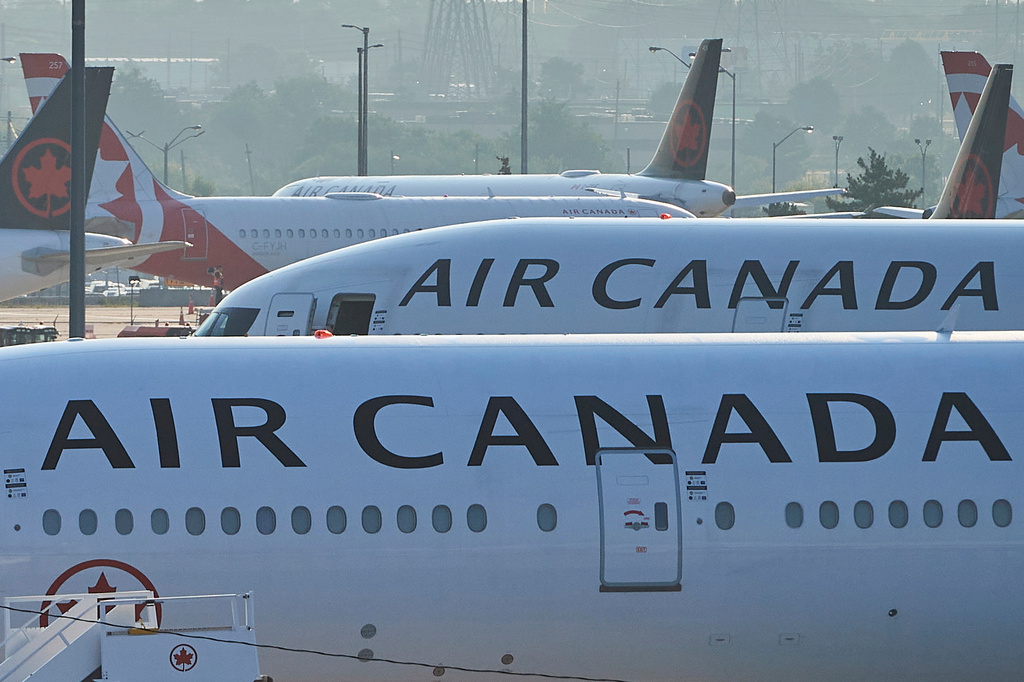 FILE - Air Canada planes sit on the runway at Pearson International Airport in Toronto on Aug. 16, 2025. (Sammy Kogan/The Canadian Press via AP, File)