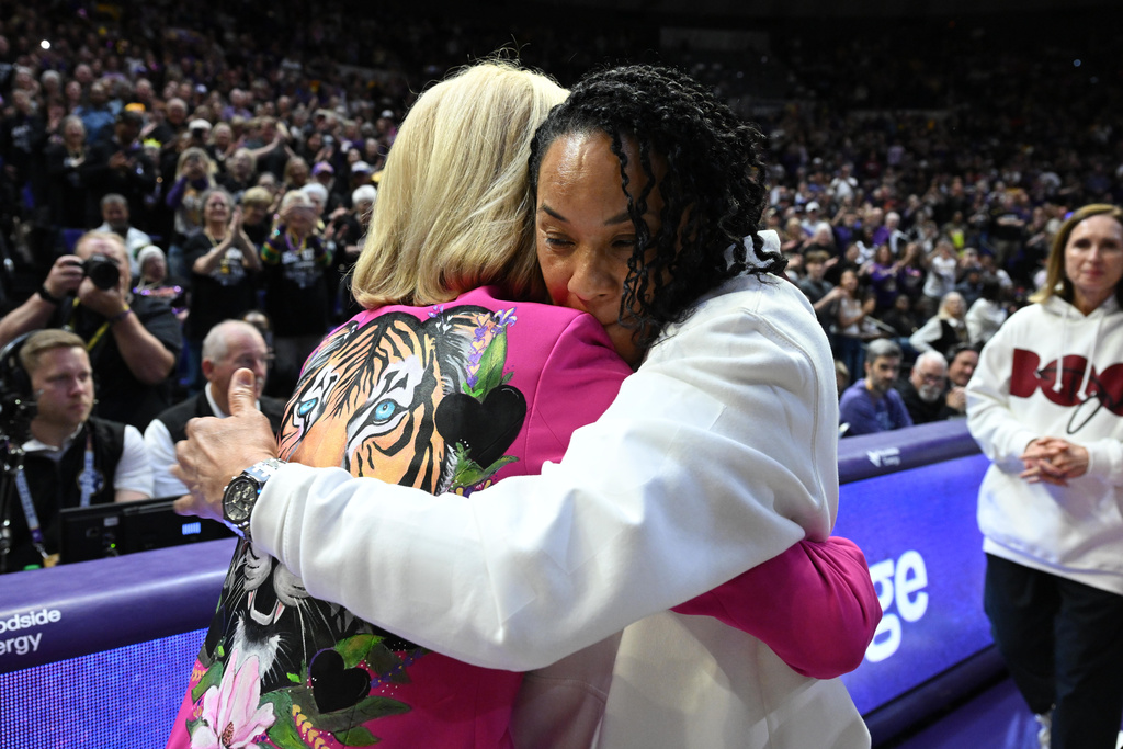 LSU head coach Kim Mulkey (left) and South Carolina head coach Dawn Staley (right) meet during pregame in an NCAA women's college basketball game in Baton Rouge, Saturday, Feb. 14, 2026. (AP Photo/Ella Hall)