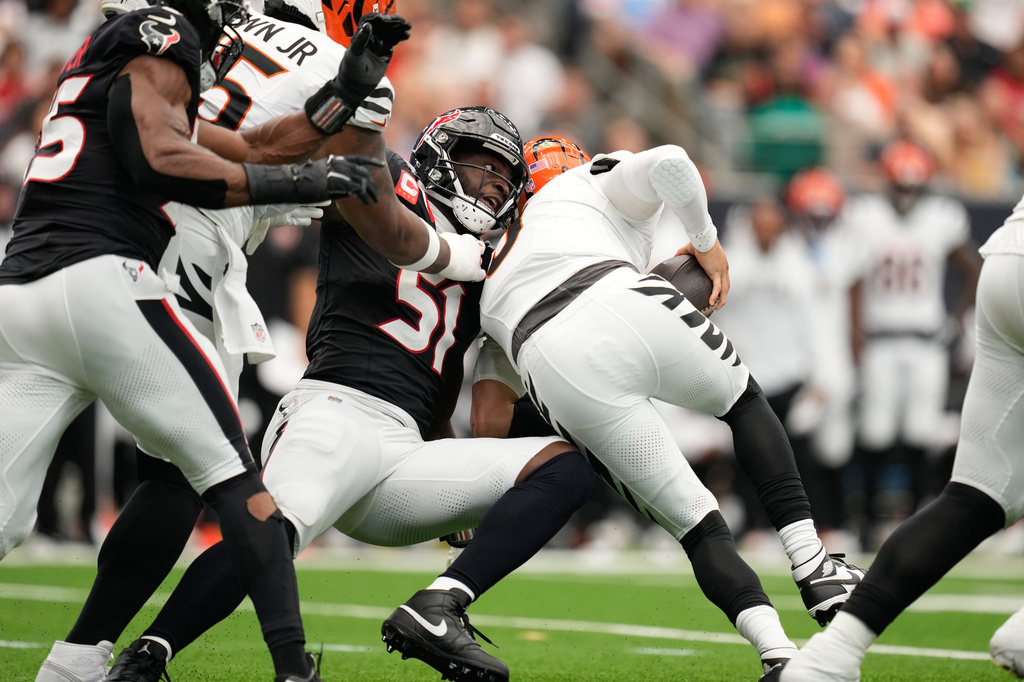 Houston Texans defensive end Will Anderson Jr. (51) sacks Cincinnati Bengals quarterback Joe Burrow (9), right, during the first half of an NFL football game in Houston, Sunday, Sept. 20, 2026. (AP Photo/Ashley Landis)