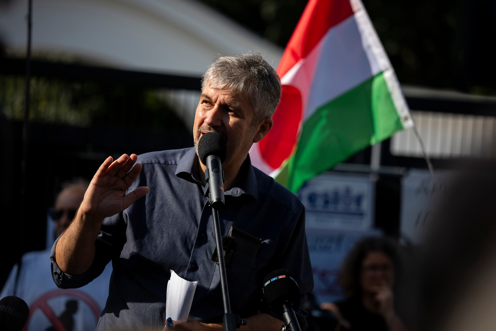 Independent lawmaker Ákos Hadházy gives a speech during a protest outside Hatvanpuszta, a country estate linked to alleged corruption involving Prime Minister Viktor Orbán, near Alcsútdoboz in Hungary, Saturday, Sept. 27, 2025. (AP Photo/Denes Erdos)