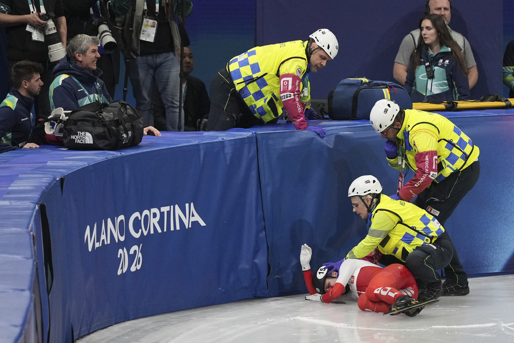 Kamila Sellier of Poland is helped after a fall during the women's 1,500 meters short track speed skating quarterfinal at the 2026 Winter Olympics, in Milan, Italy, Friday, Feb. 20, 2026. (AP Photo/Stephanie Scarbrough)