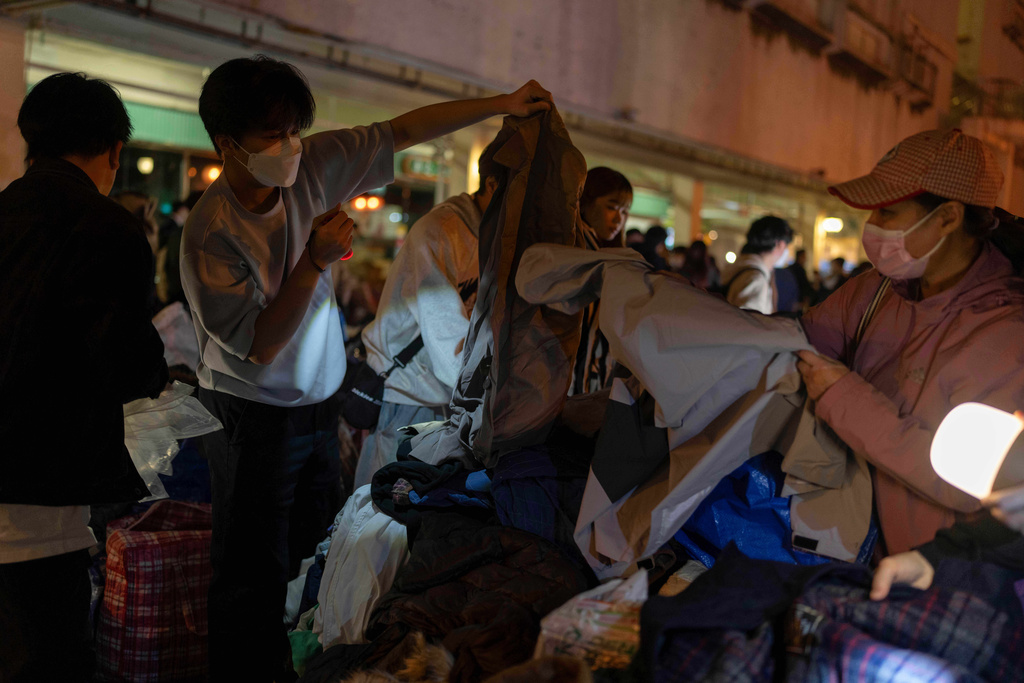 Volunteers provide warm clothings for residents in the aftermath of a fire at Wang Fuk Court, a residential estate in the Tai Po district of Hong Kong's New Territories, Thursday, Nov. 27 2025. (AP Photo/Ng Han Guan)