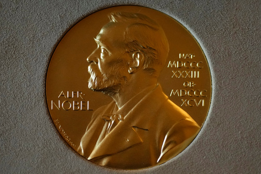 FILE - A Nobel Prize medal is displayed before a ceremony at the Swedish Ambassador's Residence in London, Monday, Dec. 6, 2021. (AP Photo/Matt Dunham, File) FILE - A Nobel Prize medal is displayed before a ceremony at the Swedish Ambassador's Residence in London, Monday, Dec. 6, 2021. (AP Photo/Matt Dunham, File)