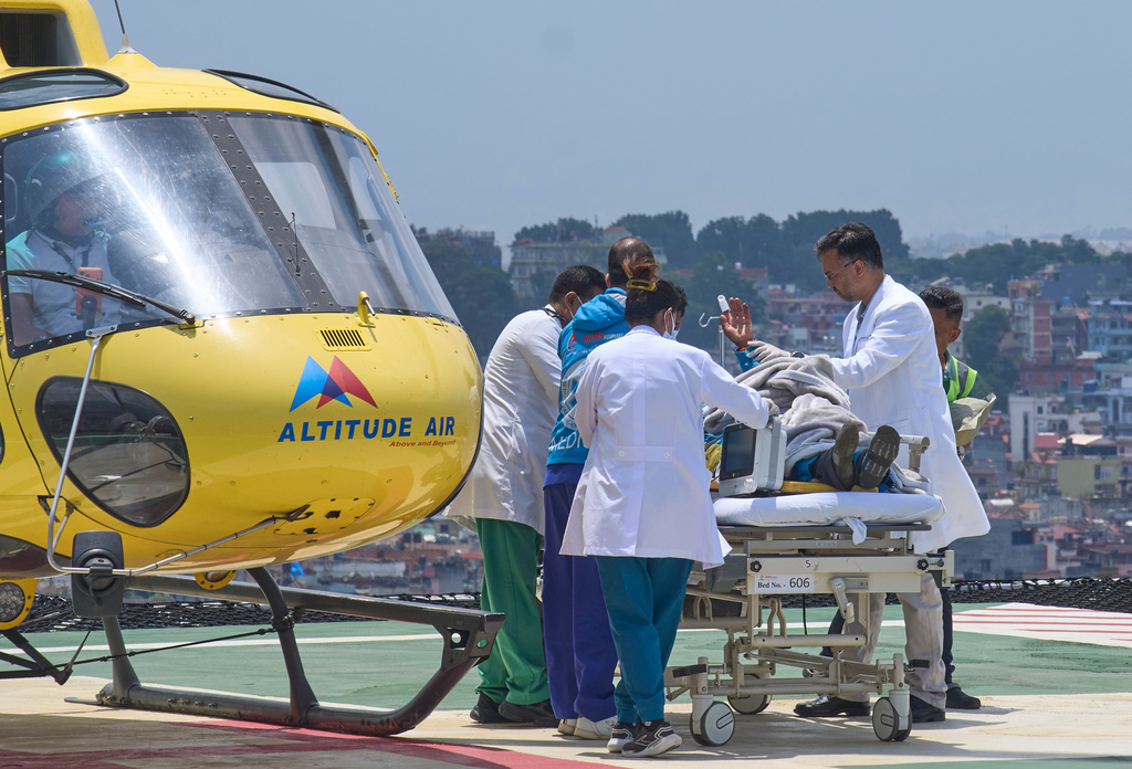 Medics take Dawa Sherpa, a mountain guide who had been missing for several days in the Everest region, for treatment after he arrived at Grande Hospital in Kathmandu, Nepal, Thursday, June 4, 2026. (AP Photo/Niranjan Shrestha)