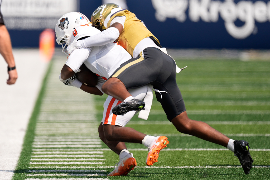 Georgia Tech defensive back Daiquan White (4) hits Mercer wide receiver Eric Rasheed (0) in the first half of an NCAA college football game, Saturday, Sept. 19, 2026, in Atlanta. (AP Photo/Mike Stewart)