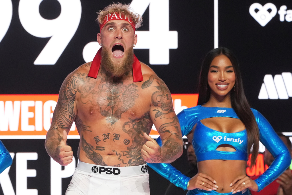 FILE - Jake Paul, front, reacts for photographers during a ceremonial weigh-in ahead of his cruiserweight boxing match against Julio Cesar Chavez Jr., Friday, June 27, 2025, in Anaheim, Calif. (AP Photo/Chris Pizzello, File)