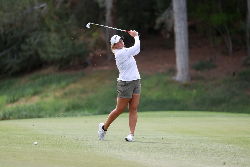 Lauren Coughlin hits an approach shot on the ninth hole during the first round of the Aramco Championship LPGA golf tournament, Thursday, April 2, 2026, in North Las Vegas. (AP Photo/Ian Maule)