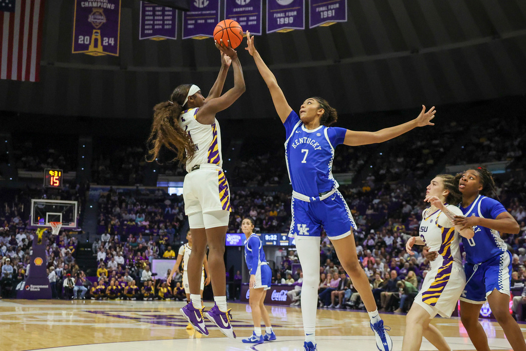 LSU guard Flau'Jae Johnson, left, shoots a jumper over Kentucky forward Teonni Key (7) in the second half of an NCAA college basketball game in Baton Rouge, La., Thursday, Jan. 1, 2026. (AP Photo/Peter Forest)