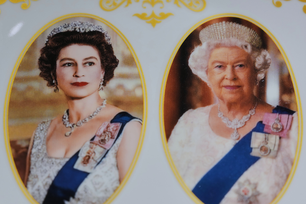 A plate with photos of late Queen Elizabeth II is on display for sale at a souvenirs shop in London, on April 17, 2026. (AP Photo/Kin Cheung)