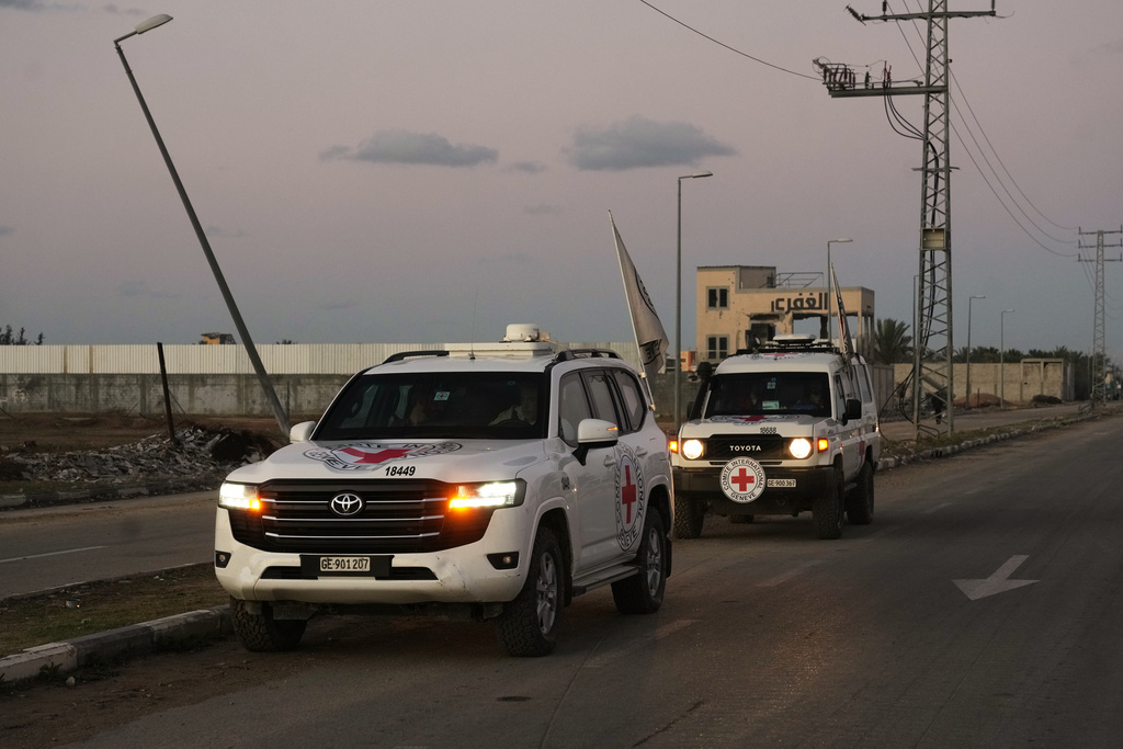 Red Cross convoy carrying the remains of a person believed to be a deceased hostage handed over by Gaza militants makes its way toward the border crossing with Israel, to be transferred to Israeli authorities, in Deir al-Balah, central Gaza Strip, Tuesday, Nov. 25, 2025. (AP Photo/Abdel Kareem Hana)