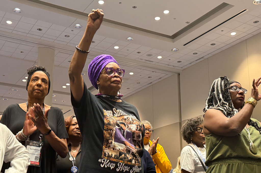 Attendees gesture at a news conference about the results of an independent autopsy of Nolan Wells at the NAACP National Convention in Chicago, Wednesday, July 22, 2026. (AP Photo/Laura Bargfeld)