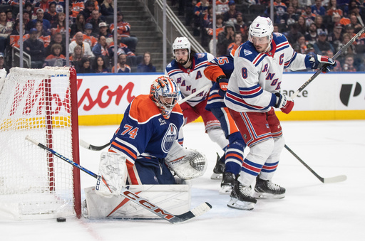 New York Rangers' J.T. Miller (8) is stopped by Edmonton Oilers goalie Stuart Skinner (74) during third-period NHL hockey game action in Edmonton, Alberta, Thursday, Oct. 30, 2025. (Jason Franson/The Canadian Press via AP) New York Rangers' J.T. Miller (8) is stopped by Edmonton Oilers goalie Stuart Skinner (74) during third-period NHL hockey game action in Edmonton, Alberta, Thursday, Oct. 30, 2025. (Jason Franson/The Canadian Press via AP)