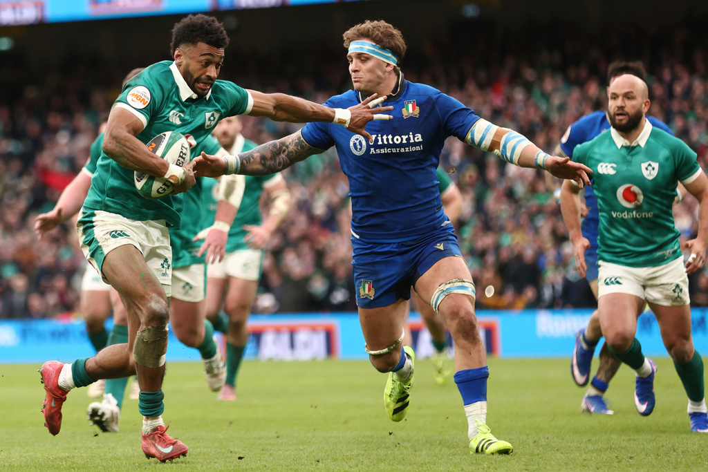 Ireland's Robert Baloucoune, left, runs onto score a try despite Italy's Lorenzo Cannone's late defence during a Six Nations rugby union match between Ireland and Italy in Dublin, Ireland, Saturday, Feb. 14, 2026. (AP Photo/Peter Morrison)