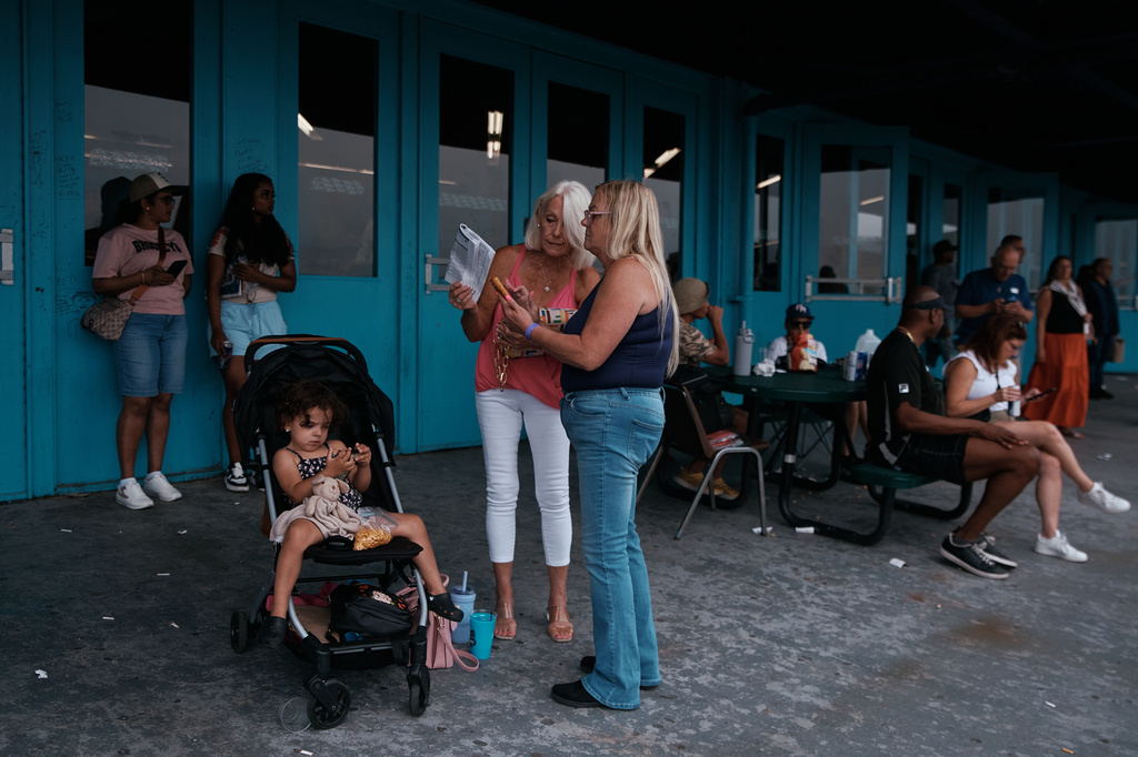 People gather outside the grandstand at Aqueduct Racetrack in the Queens borough of New York, Saturday, June 27, 2026. (AP Photo/Andres Kudacki)