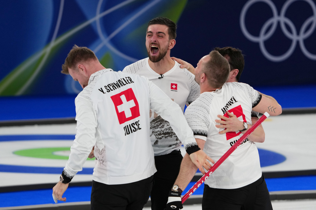 Switzerland's Benoit Schwarz-van Berkel, Yannick Schwaller, Sven Michel and Pablo Lachat-Couchepin celebrate winning a men's curling bronze medal match between Norway and Switzerland, at the 2026 Winter Olympics, in Cortina d'Ampezzo, Italy, Friday, Feb. 20, 2026. (AP Photo/Misper Apawu)