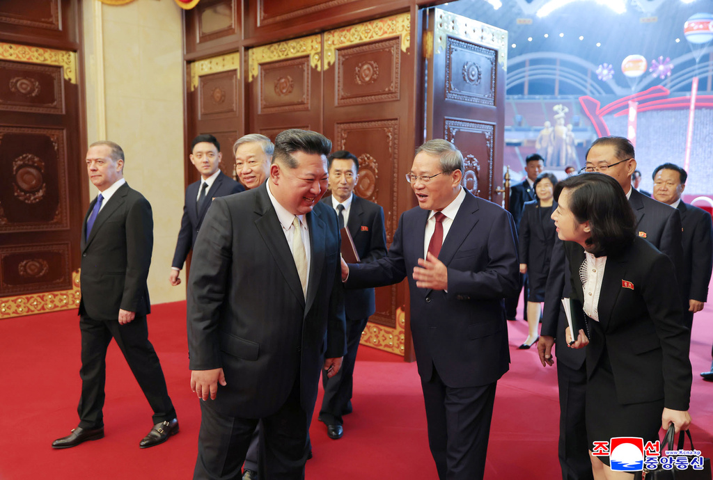 In this photo provided by North Korean government, North Korean leader Kim Jong Un, front left, talks with Chinese Premier Li Qiang, front center, during a ceremony marking the 80th anniversary of the ruling Workers’ Party in Pyongyang, North Korea, Thursday, Oct. 9, 2025. Independent journalists were not given access to cover the event depicted in this image distributed by the North Korean government. The content of this image is as provided and cannot be independently verified. Korean language watermark on image as provided by source reads: "KCNA" which is the abbreviation for Korean Central News Agency. (Korean Central News Agency/Korea News Service via AP)