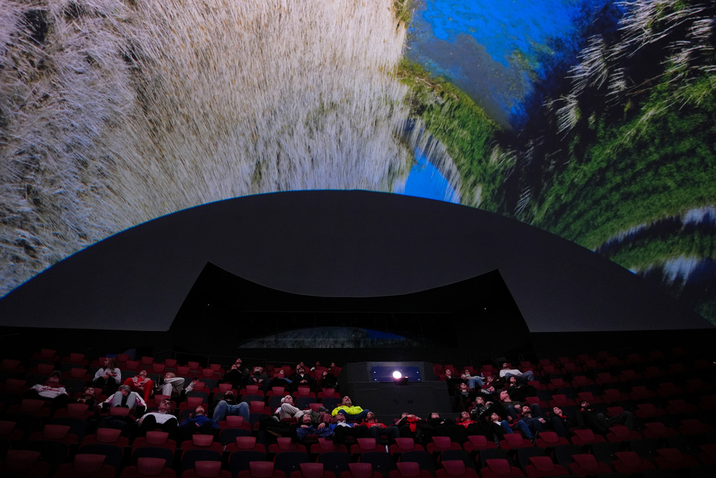 Audience members watch "Ohio: Wild at Heart" that features the state's top-rated park system to highlight wildlife conservation efforts and the restorative power of outdoor recreation at the Robert D. Lindner Family OMNIMAX Theater at the Cincinnati Union Terminal, Tuesday, Dec. 30, 2025, in Cincinnati. (AP Photo/Carolyn Kaster)
