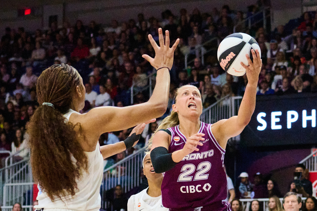 Toronto Tempo's Julie Allemand (22) drives to the net past Atlanta Dream's Naz Hillmon, left, during the first half of a WNBA basketball game in Toronto, Sunday, June 14, 2026. (Sammy Kogan/The Canadian Press via AP)