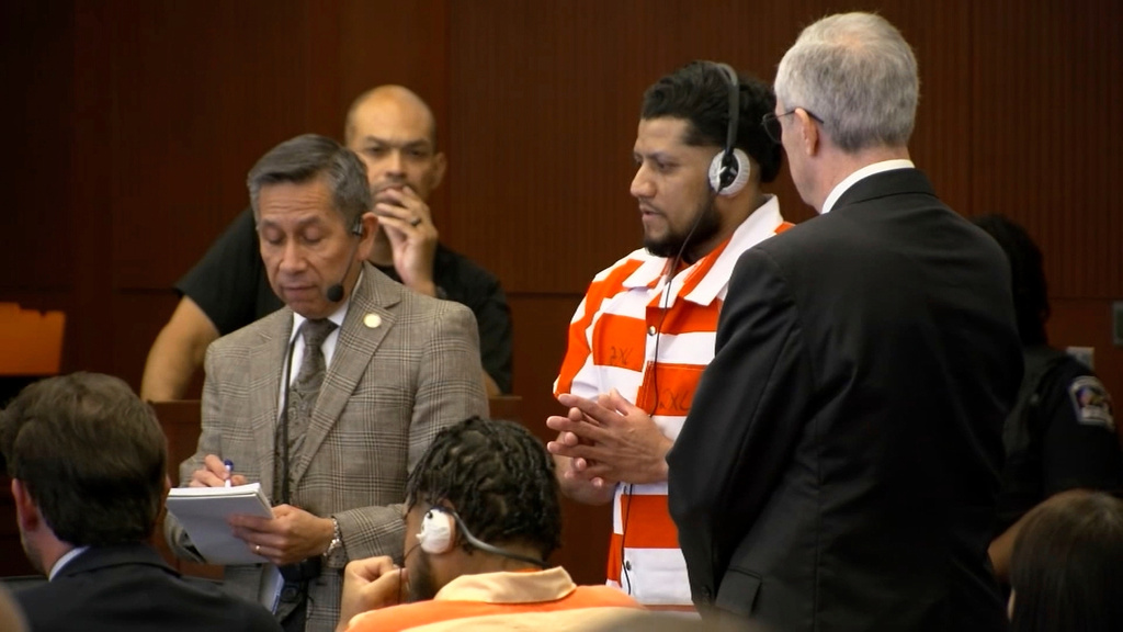 In this image taken from video provided by WTVD-TV, Arturo Marin-Sotelo, center, standing, speaks through an interpreter during a hearing on charges related to the killing of a North Carolina sheriff's deputy in 2022, Tuesday, Sept. 16, 2025, in Raleigh, N.C. (AP Photo/WTVD-TV)