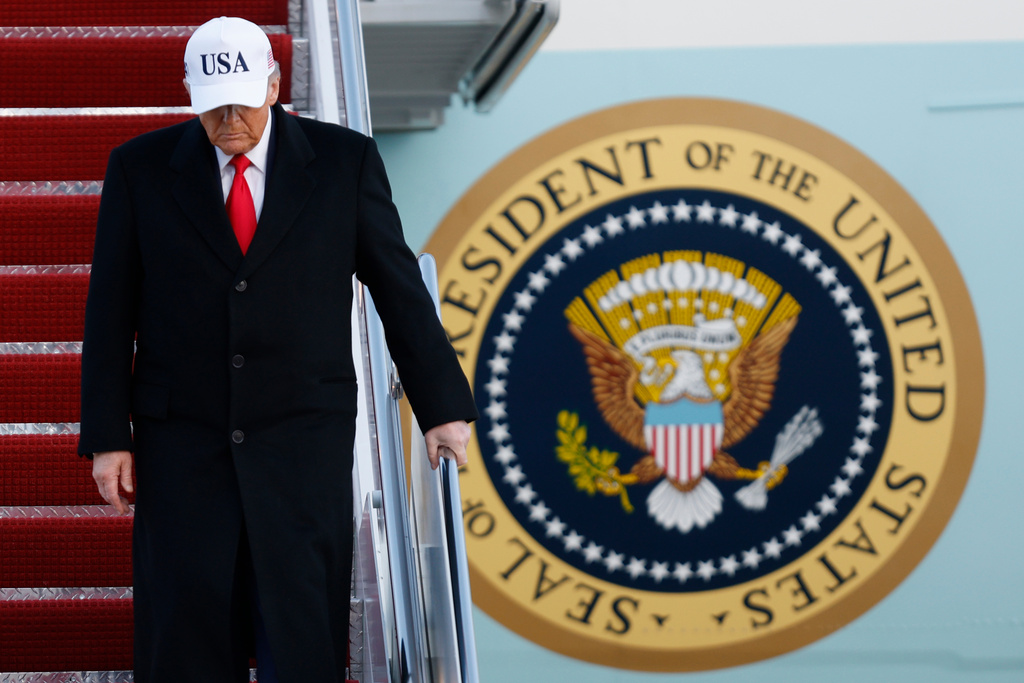 President Donald Trump walks down the stairs of Air Force One upon his arrival at Joint Base Andrews, Md., Tuesday, Jan. 13, 2026. (AP Photo/Luis M. Alvarez)