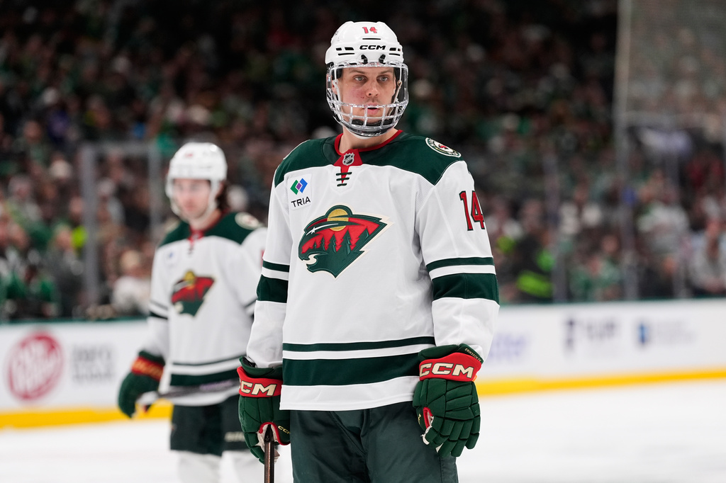 Minnesota Wild center Joel Eriksson Ek wears a mask after suffering an unknown facial inury in the first period of an NHL hockey game against the Dallas Stars, Thursday, April 9, 2026, in Arlington, Texas. (AP Photo/Tony Gutierrez)