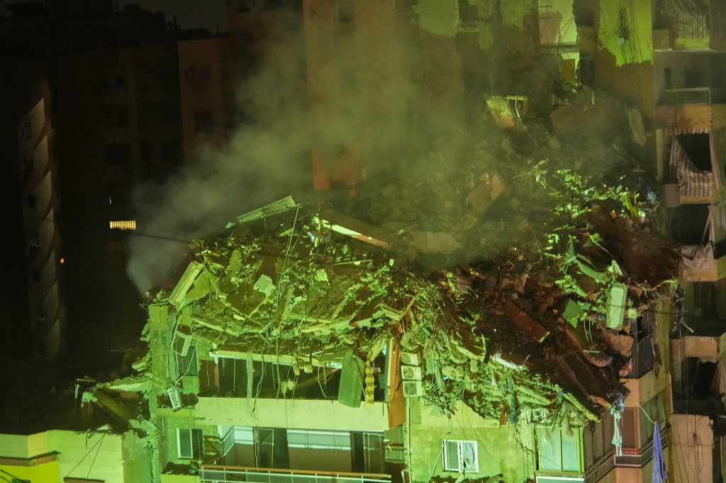 Smoke rises from the rubble of a heavily damaged building following an Israeli airstrike in Dahiyeh, Beirut's southern suburbs, Lebanon, Wednesday, May 6, 2026. (AP Photo/Hassan Ammar)