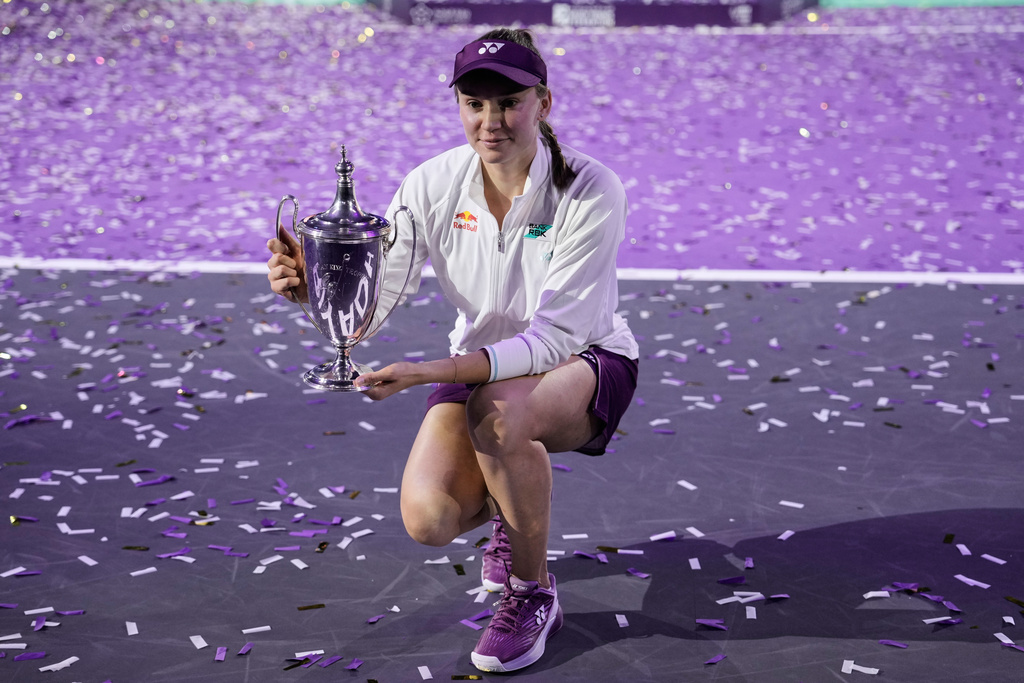 Elena Rybakina of Kazakhstan poses with the trophy after defeating Aryna Sabalenka of Belarus in the women's final singles match of the WTA finals in Riyadh, Saudi Arabia, Saturday, Nov. 8, 2025. (AP Photo/ Fatima Shbair)