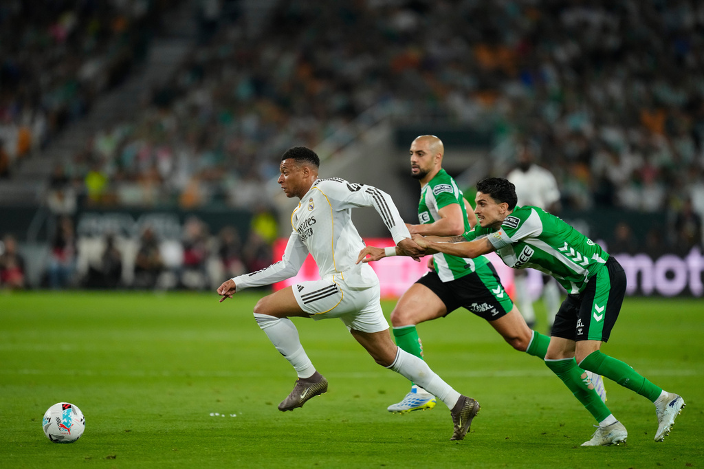 Betis' Marc Bertra holds Real Madrid's Kylian Mbappe during a La Liga soccer match between Real Betis and Real Madrid in Seville, Spain, Friday, April 24, 2026. (AP Photo/Jose Breton)