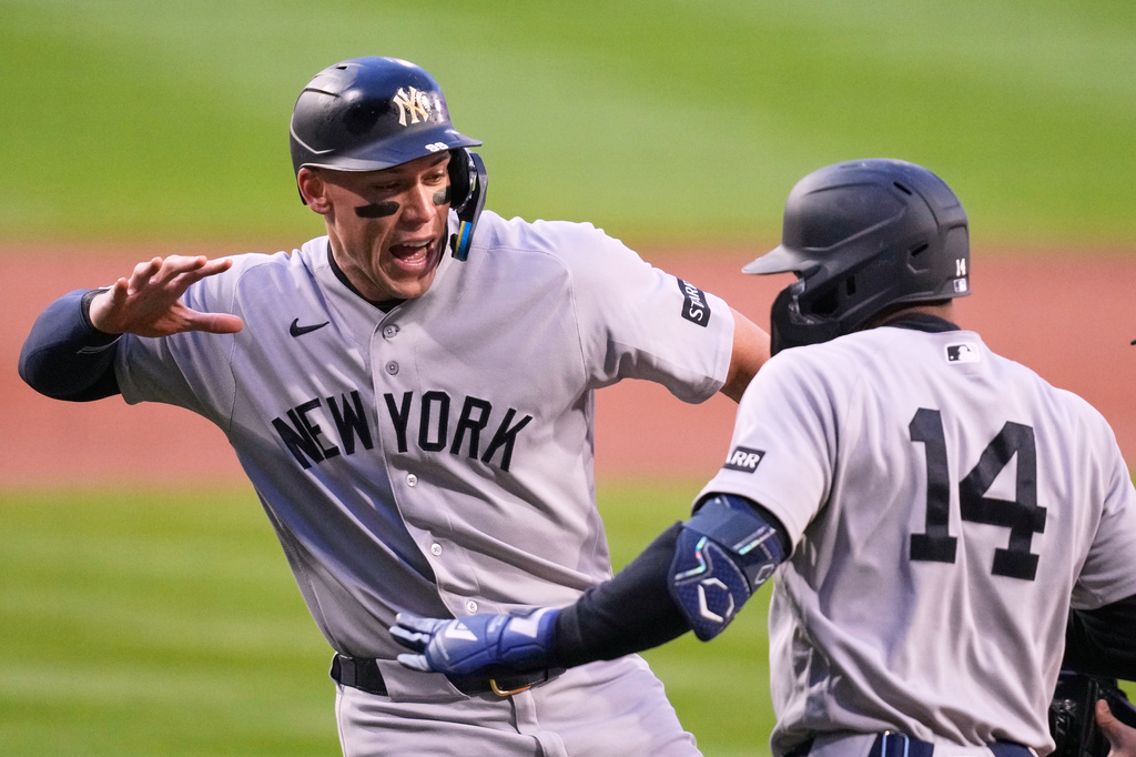 New York Yankees' Amed Rosario (14) is congratulated by Aaron Judge after Rosario's three run home run in the first inning off Boston Red Sox pitcher Ranger Suarez during a baseball game at Fenway Park, Wednesday, April 22, 2026, in Boston. (AP Photo/Charles Krupa)