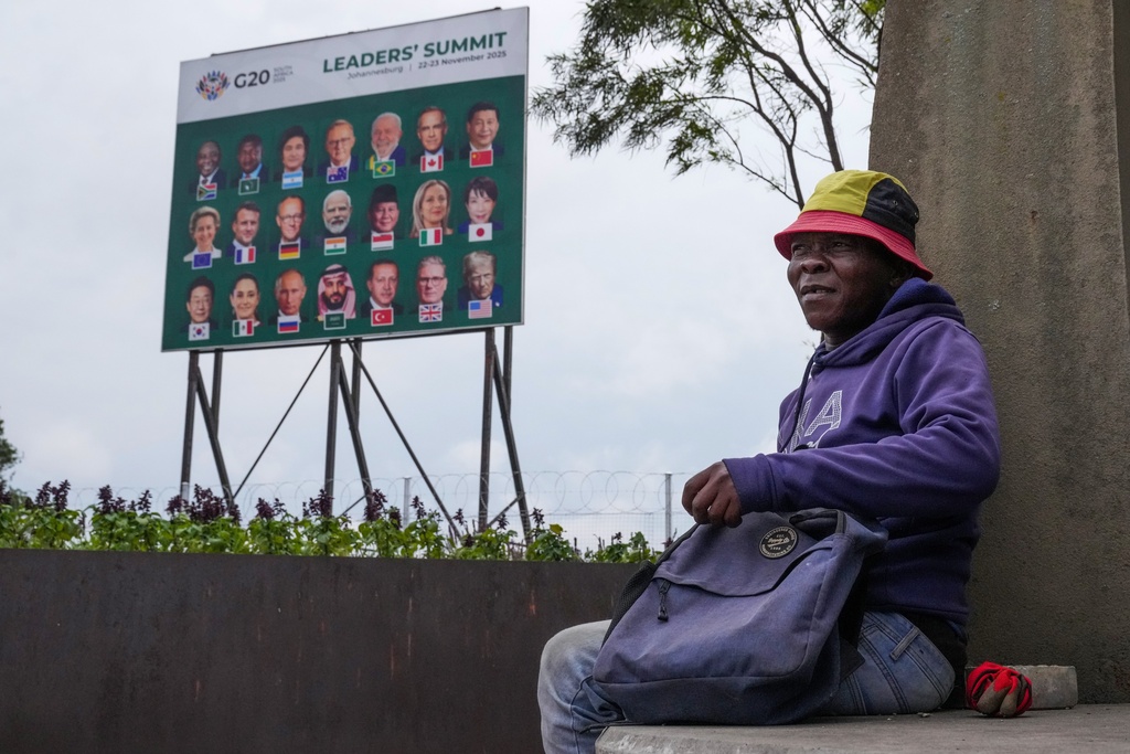A gardener takes his lunch break as a massive cleanup job gets underway in anticipation of the upcoming G20 summit to be held in the South African economic capital, Friday, Nov. 14, 2025. (AP Photo/Jerome Delay)