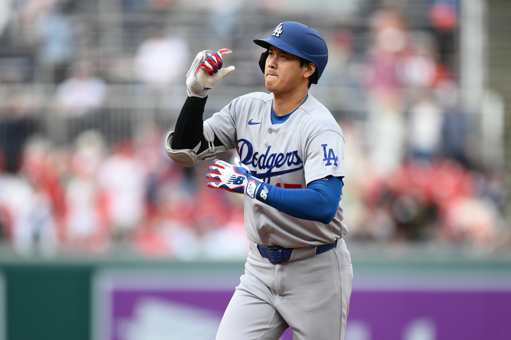 Los Angeles Dodgers' Shohei Ohtani celebrates his home run as he rounds the bases during the third inning of a baseball game against the Washington Nationals, Sunday, April 5, 2026, in Washington. (AP Photo/Nick Wass)