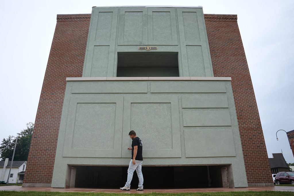 Wesley Mast, owner and president of Coppes Napanee, walks past a giant replica of a Hoosier cabinet in Nappanee, Ind., Thursday, Aug. 6, 2026. (AP Photo/Obed Lamy)