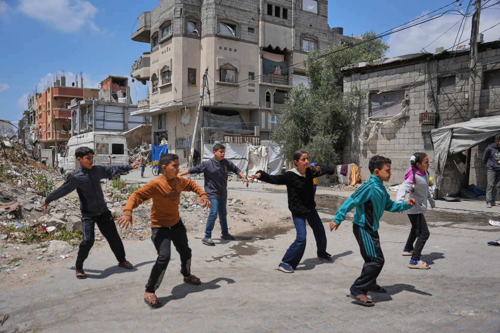 Palestinian children practice breakdancing outside a dance studio in Nuseirat, central Gaza Strip, Monday, May 4, 2026. (AP Photo/Abdel Kareem Hana)