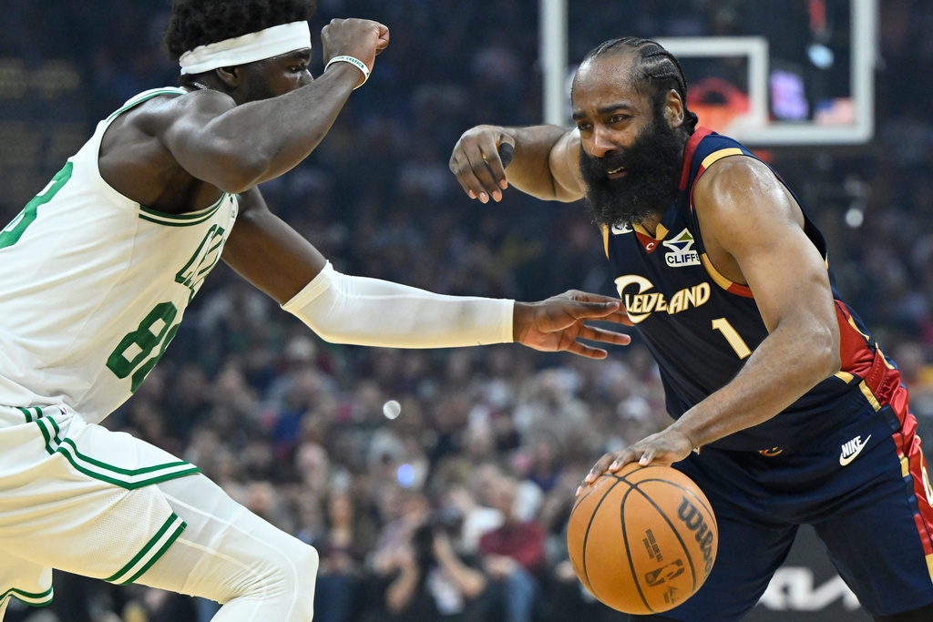 Cleveland Cavaliers guard James Harden (1) dribbles beside Boston Celtics center Neemias Queta in the first half of an NBA basketball game in Cleveland, Sunday, March 8, 2026. (AP Photo/David Richard)